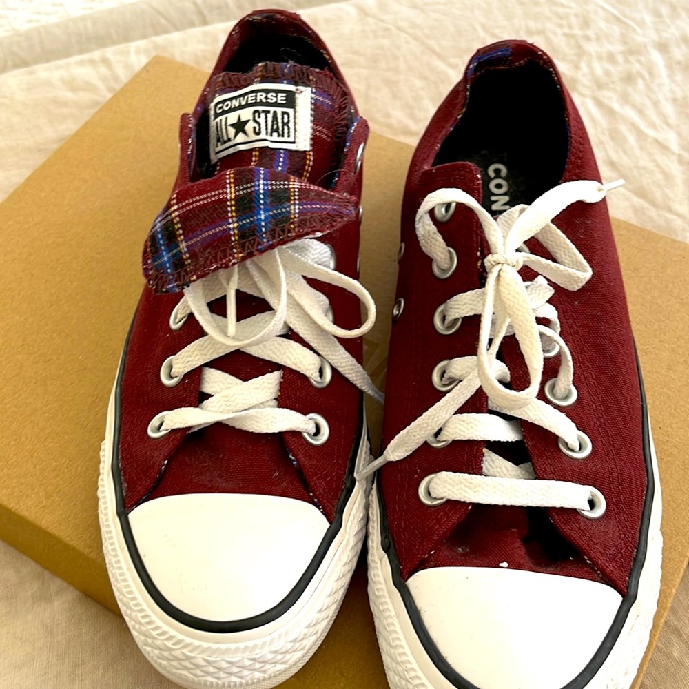 Women’s burgundy converse with tartan accent tongue.